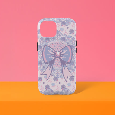 Coquette phone case featuring a pastel purple bow and pink floral lace background, dual-layer protection, UV protected, compatible with iPhone, Samsung Galaxy, and Google Pixel.