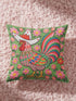 Square throw pillow cover with a printed faux embroidery design of a rooster wearing a white cowboy hat with red stars on a grass green background. The western chicken has a red comb and wattle, yellow beak and feet, and layered feathers in pink, green, orange, blue, and yellow with a rainbow striped tail. Pink and red flowers with yellow centers frame the bird. The stitched look is a flat 2D print on a smooth linen feel polyester cover with a hidden zipper, not raised embroidery.
