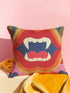 A square, linen-textured pillowcase featuring a colorful, maximalist illustration of an open mouth with bright red lips and large white vampire fangs. The central graphic is framed by concentric, retro-style stripes in shades of red, orange, green, and blue, creating a bold, vintage-goth aesthetic.
