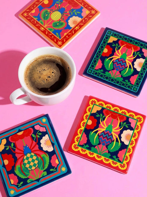 A set of four square coasters featuring a glossy glazed finish and vibrant insect illustrations. Each coaster measures approximately four by four inches. The designs showcase symmetrical beetles and spiders in bold red, blue, and orange colors, framed by intricate floral and geometric borders in a maximalist folk art style. Available in ceramic with cork backing or hardboard MDF. The edges are smooth. The designs are vivid and highly saturated, designed to provide grip and protect furniture.