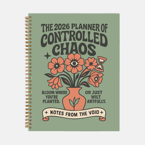 A sage green hardcover spiral planner for 2026 with the title "The 2026 Planner of Controlled Chaos" in a funky, retro 70s-style font. The cover features a groovy illustration of orange and pink flowers in a vase, with one flower depicted as an eyeball. The text reads "Bloom where you're planted. Or just wilt artfully." and "Notes from the Void." The planner has a gold metal wire-o binding. The back cover shows a decorative floral frame with a "Property Of" section