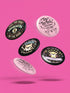 A collection of four retro-style 1.75 inch pinback buttons featuring the text "Tax the Rich" and "Pet the Dogs." Designs include: 1) A black pin with a crystal ball and gold filigree, 2) A pink pin with floral accents and a happy dog, 3) A black pin with a spooky chihuahua holding a bone, and 4) A black pin with a cute devil-horned puppy and lavender banner. High-gloss finish with psychedelic 70s typography. Perfect for battle vests or backpacks. Funny anti-capitalist dog lover gift.