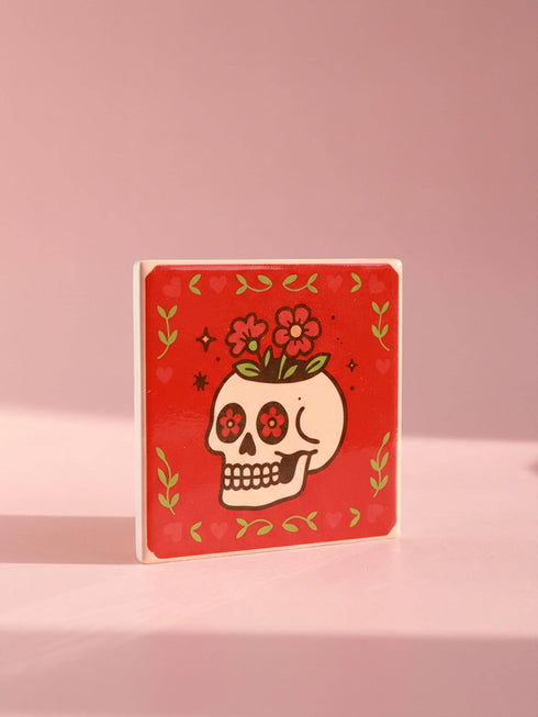 Set of four square glazed ceramic coasters featuring a vibrant pastel goth and creepy cute design. These functional art pieces show a spooky yet playful aesthetic perfect for alternative home decor. The coasters have a glossy wipe-clean finish and a non-slip cork backing to protect furniture surfaces from hot and cold beverages. Ideal for maximalist coffee tables, witchy desks, or as a unique housewarming gift for horror fans who love retro 70s and dopamine decor styles.