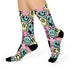 Fun and vibrant socks adorned with a 90s-inspired design of melting smiley faces in various colors, with black heels and toes, perfect for those who love retro and unique styles.