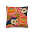 A square linen-feel throw pillow with a vibrant, maximalist print on a bright pink background. The pattern features two large, illustrated possums (or sugar gliders). The animals are nestled amongst large, 70s-style retro floral designs in shades of orange, marigold yellow, and turquoise, with avocado green leaves. The pillow has a textured, woven appearance, mimicking a high-end linen fabric. The double-sided print is colorful, eclectic, and groovy, with a distinct vintage 70s folk art feel.