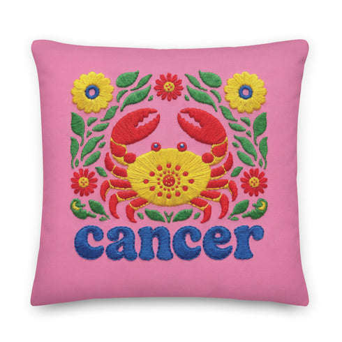 A square pink pillowcase features a vibrant, multi-colored design centered around a yellow and red crab representing the Cancer zodiac sign. The design is framed by symmetrical green leaves and yellow and red flowers. The word "cancer" is written in a bold, blue, rounded font at the bottom. The visual texture mimics intricate raised embroidery with visible stitch patterns, though the surface is a smooth 2D print on a linen-textured polyester fabric with a hidden zipper.