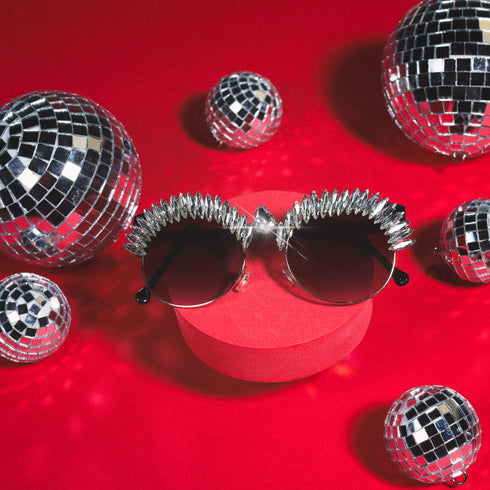 a pair of sunglasses sitting on top of a red box