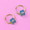 a pair of gold hoop earrings with evil eye on them