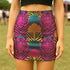High-waisted mini skirt with bold psychedelic tiger print in hot pink, teal, yellow, and black. Features a form-fitting pencil silhouette with an elastic waistband. Available in eco-poly performance or glitter finish. Unique maximalist style for festivals, summer parties, or rave fashion. Sizes S–XL.