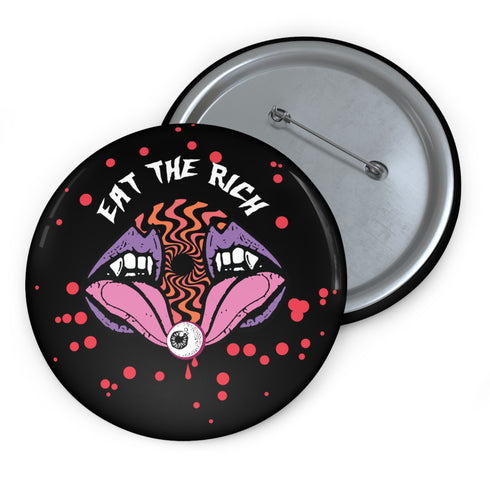 Black circular pin badge with purple fanged mouths design, psychedelic orange spiral, and "EAT THE RICH" text in white, scattered with red dots