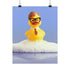 A humorous fine art print of a rubber duck modeled after Dwight Schrute, complete with glasses, mustard tie, and serious expression. Floating in soap suds, the print is framed above a retro bed with bold orange flower wallpaper and bright accent pillows.