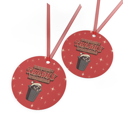 Round red metal Christmas ornament featuring angry possum in Santa hat emerging from trash can. Text reads "Have Yourself a Trashy Little Christmas" in dripping font with stars.