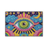 Rectangular entryway doormat with a deep purple background printed in a 2D faux embroidery illusion. The symmetrical mandala centers on a large green, pink, and white evil eye with golden yellow sunburst lines radiating outward. The corners hold textured cyan clouds, yellow crescent moons, and stars, with a scalloped floral motif along the lower edge. Finished with black trim and a non-slip rubber backing. Psychedelic celestial maximalist home decor and protective evil eye welcome mat for bold, eclectic ent