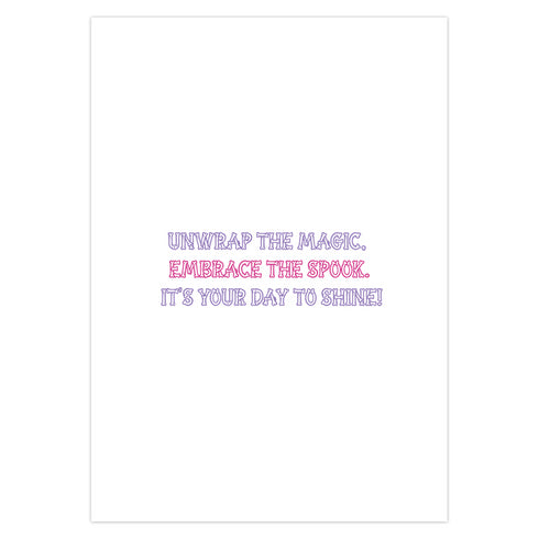 Birthday card with vibrant yellow background. A pink and green skeletal hand holds a purple and pink gift box with large pink bow. The illustration blends festive and spooky elements, creating a playful Halloween-meets-birthday aesthetic. The stylized, colorful design uses contrasting bright colors for a eye-catching effect. Inside message reads: 'Unwrap the Magic. Embrace the Spook. It's Your Day to Shine!' - combining celebratory spirit with a touch of the macabre for a unique birthday greeting.