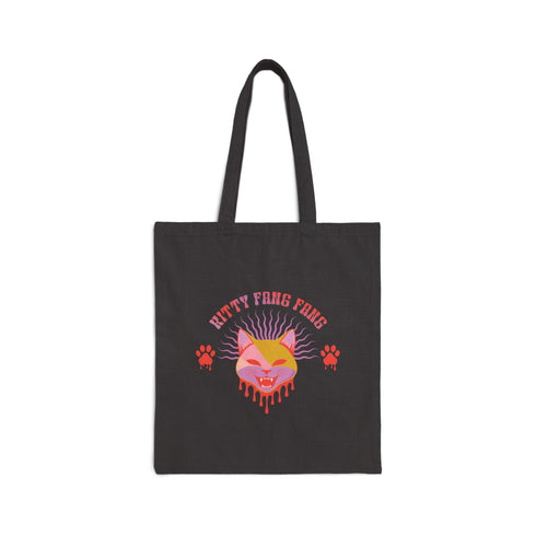 Edgy cat tote with attitude. Vibrant pink and orange design features snarling feline face, dripping fangs, and 'Kitty Fang Fang' text. Playful yet fierce vibe on natural canvas. Perfect for cat lovers with a wild side.