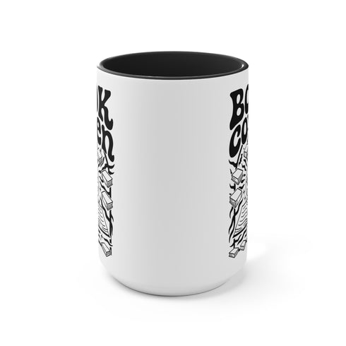 A two-tone ceramic mug with a glossy white exterior and a contrasting black interior, handle, and rim. The front of the mug features a black, rectangular graphic with the words "BOOK COVEN" in a bold, wavy, 70s-inspired retro font. Below the text is an occult-style illustration of an open book on a stand. An all-seeing eye with a snake coiled around it emerges from the book's pages, radiating lines of light. Smaller books float around the central image, completing the witchy, bookish design