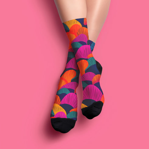 Colorful crew socks featuring a bold, fan-shaped mushroom pattern in orange, magenta, teal, yellow, and purple on a deep navy background. The design is vibrant and psychedelic, perfect for statement-making fashion. The socks are mid-calf length with reinforced heel and toe, made from a stretchy polyester, nylon, and spandex blend for comfort and durability.