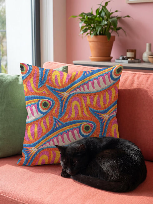 Flat printed square throw pillow cover featuring a faux embroidery texture. The vibrant maximalist design showcases stylized blue, pink, yellow, and white fish swimming in a dynamic, swirling pattern across a bright orange background. The artwork mimics heavy crewelwork yarn and stitching, but the material is a smooth 2D flat print. The pillow is shown as a finished square cover, designed to add bright, colorful eclectic fisherman aesthetic decor to any sofa or seating area.