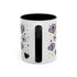 The Gothic Read Dangerously Mug Accent Coffee Mug (11, 15oz) features a black handle and interior, purple spell book and skull illustrations, black hearts, colorful stars, is BPA-free, and has a glossy finish for safe and stylish sipping.