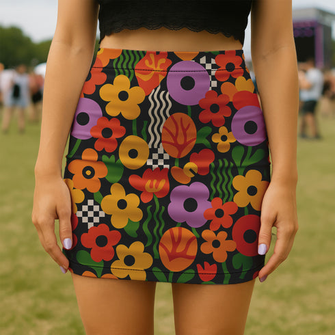Honey Dazed retro floral mini skirt in a fitted pencil silhouette with high waist. Features a groovy all-over print of oversized flowers, checkers, waves, and bold 70s-inspired shapes in orange, red, purple, green, and yellow. Designed with a soft, sculpting stretch fabric for all-day comfort and drama. A statement piece made for maximalists, festival-goers, and vintage fashion freaks. Perfect for layering with puff sleeves and platform boots.