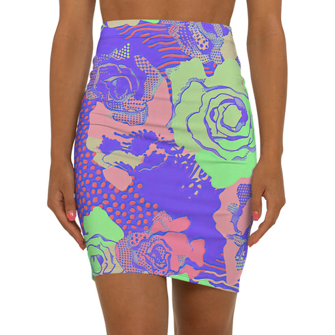 High-waisted bodycon mini skirt with a bold floral collage print in green, purple, and pink. Features comic-style roses and dot patterns on stretchy polyester-spandex fabric. Styled for festivals and summer parties. Available in sizes XS to XL.