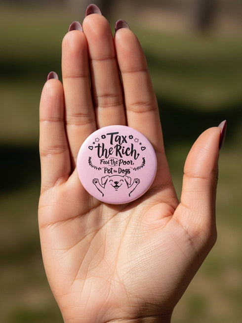 A collection of four retro-style 1.75 inch pinback buttons featuring the text "Tax the Rich" and "Pet the Dogs." Designs include: 1) A black pin with a crystal ball and gold filigree, 2) A pink pin with floral accents and a happy dog, 3) A black pin with a spooky chihuahua holding a bone, and 4) A black pin with a cute devil-horned puppy and lavender banner. High-gloss finish with psychedelic 70s typography. Perfect for battle vests or backpacks. Funny anti-capitalist dog lover gift.