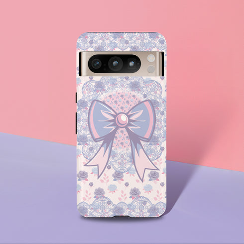 Coquette phone case featuring a pastel purple bow and pink floral lace background, dual-layer protection, UV protected, compatible with iPhone, Samsung Galaxy, and Google Pixel.