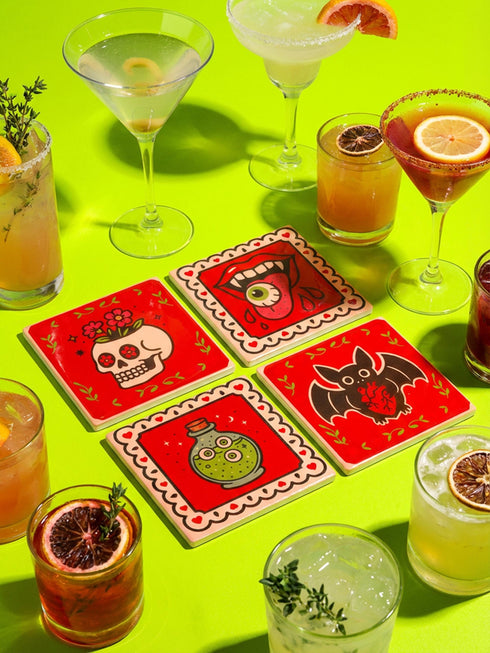 Set of four square glazed ceramic coasters featuring a vibrant pastel goth and creepy cute design. These functional art pieces show a spooky yet playful aesthetic perfect for alternative home decor. The coasters have a glossy wipe-clean finish and a non-slip cork backing to protect furniture surfaces from hot and cold beverages. Ideal for maximalist coffee tables, witchy desks, or as a unique housewarming gift for horror fans who love retro 70s and dopamine decor styles.