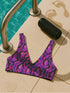 Psychedelic crystal bikini top featuring a vivid print of pink and purple crystals with wavy neon accents on a black background. Sports bra-style top with a scoop neckline, wide shoulder straps, and removable padding. Made of recycled polyester and LYCRA XTRALIFE with UPF 50+ sun protection. Available in sizes XS to 3XL. Double-layered construction with a snug, secure fit. Sustainable swimwear top for rave, beach, or summer festival wear.