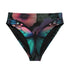 High-waisted bikini bottom with a gothic butterfly print in rich teal, plum, and midnight tones on a black background. Features kaleidoscopic wings forming a central butterfly motif across the front, with a flattering cheeky cut and double-layered fabric. Styled on a turquoise pool backdrop, this moody festival swimwear is perfect for soft goths, rave queens, and dark summer rebels.