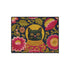 High-fidelity printed doormat featuring a "Space Kitty" design in a tapestry-style faux-texture. A black cat with large yellow eyes wears a golden ribbed space helmet, centered on a deep navy background. The cat is surrounded by oversized, vibrant magenta and pink folk-art flowers with chartreuse and olive green leaves. The design uses a printed illusion to mimic 3D embroidery stitching. The mat is rectangular with a sleek black border and a non-slip backing.