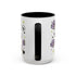 The Gothic Read Dangerously Mug Accent Coffee Mug (11, 15oz) is a white ceramic mug with a black handle and interior, decorated with purple tombstones, skulls, stars, and hearts. BPA-free and shown from the back with the handle centered.