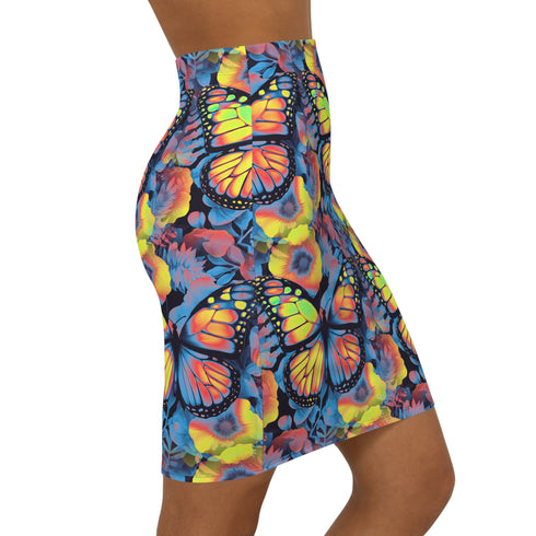 High-waisted bodycon mini skirt with an allover print of rainbow monarch butterflies and colorful tropical flowers on a dark background. Soft, stretchy poly-spandex fabric hugs the body for a flattering fit. Styled for rave, Y2K, and festival outfits. Sizes XS to XL.