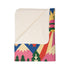A rectangular velveteen minky blanket with a bright, maximalist design. The top half features a vibrant blue sky with a pink, green, and yellow UFO beaming rays down over hot pink snow-capped mountains. The bottom half shows a grassy green field with a white cow covered in dark spots, surrounded by large, colorful red, pink, and blue retro flowers, pine trees, and a rainbow arch at the very bottom. The reverse side is a fluffy off-white sherpa.