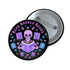 Literary rebel's badge of honor. Black circular button featuring a neon purple skeleton surrounded by floating books and stars. The text 'READ BANNED BOOKS' arcs across the top in bold purple lettering. Perfect for book-loving misfits who devour forbidden knowledge.