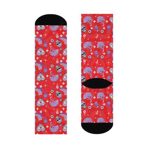 Fun and vibrant socks adorned with colorful roller skates, helmets, and wheels motifs on a red background, with black heels and toes, ideal for roller skating enthusiasts.