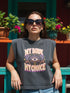 A garment dyed charcoal grey women's muscle tee featuring a slightly cropped boxy fit with structured shoulders and a wide rib collar. The front displays a retro 70s psychedelic graphic printed in purple, orange, and yellow. The text reads MY BODY MY CHOICE surrounding a central eye motif with a radial sunburst, framed by symmetrical mystical swirls and four point stars. The vintage style cotton shirt offers a faded aesthetic, presented on its own without background lifestyle elements.