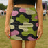 Honey Dazed bodycon mini skirt with abstract camo-inspired shapes in green, pink, black, and sage. The design mimics camouflage blobs with an amoeba-like twist in a high-waisted, stretchy silhouette. Made from eco-friendly performance fabric, this skirt is festival-ready, weirdcore-approved, and dance-floor durable. A subversive, soft-meets-tactical piece that blends retro rave energy with streetwear defiance.