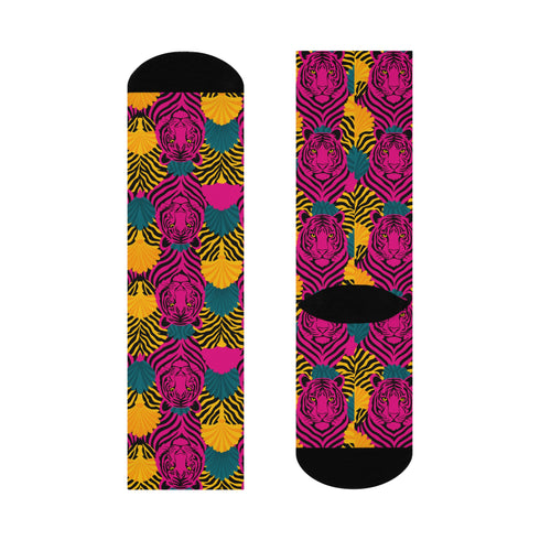 Colorful pink tiger print crew socks with black heel and toe, featuring yellow zebra stripes and teal and coral fan-shaped accents. Made of stretchy knit with a bold maximalist aesthetic. One size fits most, mid-calf length, vibrant all-over print