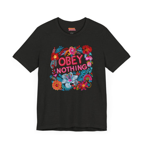 Black activist T-shirt with a floral embroidered-style design and the words “Obey Nothing” in bold, bright lettering.