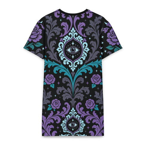Cotton t-shirt dressA short-sleeve structured t-shirt dress with a black background. The dress features a bold, vertically stacked repeating graphic print. The design includes intricate damask patterns in teal and grey, purple roses with teal leaves, and a central evil eye motif set inside an ornate frame with small four-point stars. The heavyweight fabric holds a clean, straight cut above the knee with zero drape, maintaining a sculptural, slightly boxy silhouette.