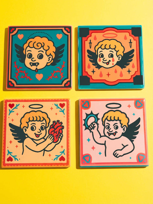 Set of four square ceramic coasters featuring a vampire cupid design in a pastel goth and traditional tattoo art style. The first coaster shows a fanged cherub on a teal background with red vines. The second features a cherub crying blood tears on a red background with daggers. The third depicts a cherub holding an anatomical heart on a peach background. The fourth shows a cherub with a spiked ring. Glossy glazed finish with cork backing. Ideal for spooky home decor and anti-valentine gifts.