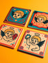 Set of four square ceramic coasters featuring a vampire cupid design in a pastel goth and traditional tattoo art style. The first coaster shows a fanged cherub on a teal background with red vines. The second features a cherub crying blood tears on a red background with daggers. The third depicts a cherub holding an anatomical heart on a peach background. The fourth shows a cherub with a spiked ring. Glossy glazed finish with cork backing. Ideal for spooky home decor and anti-valentine gifts.
