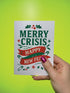 A 5x7 alternative holiday card with a white background and bold, punk-inspired typography. The text reads "Merry Crisis Happy New Fear" in dark green and red. The design features graphic elements like holly, stars, and safety pins, giving it a sarcastic, goth aesthetic. The inside message says "Consider this card your coping mechanism." This snarky, dark humor greeting card is perfect for a funny, unconventional Christmas, capturing a mental health humor and anti-capitalist vibe.