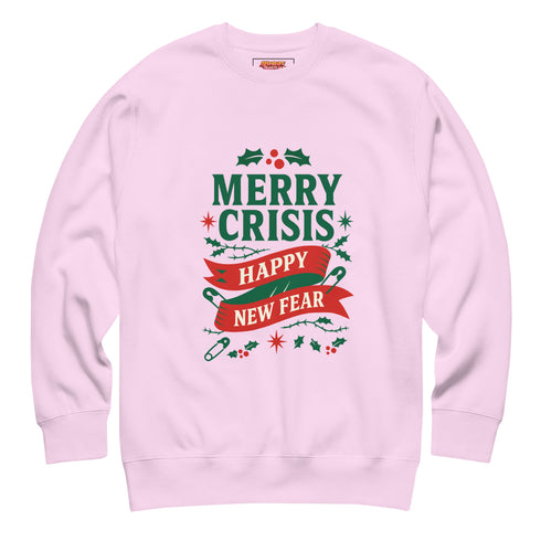 A holiday sweatshirt in pink or red with a punk and goth aesthetic. The text reads "MERRY CRISIS" and "HAPPY NEW FEAR" in a bold, gothic-style font. The design is decorated with holly leaves, berries, thorny vines, and safety pins, all arranged in a festive but alternative holiday style. This funny goth Christmas pullover is a sarcastic statement piece, perfect as dark humor apparel for the winter season.