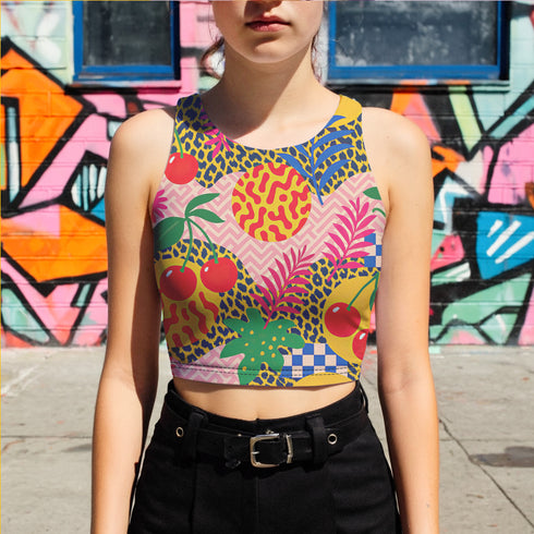 Vibrant Y2K maximalist crop top featuring bold tropical pineapples, leopard print, sweet cherries, and geometric patterns in bright yellow, pink, green, and blue colors. Perfect festival rave wear, alternative fashion, and retro summer styling for women who love aesthetic streetwear and unique party outfits