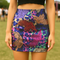 High-waisted fitted mini skirt featuring a vibrant tiger print in rainbow colors over a blue and purple camouflage background. The skirt includes a 1.5” elastic waistband and is made of eco polyester and spandex. Pencil fit hugs the body with a smooth silhouette. Available in performance or glitter finish, sizes S to XL.
