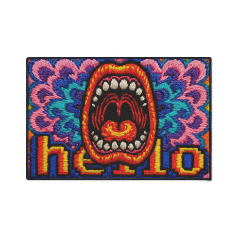 A rectangular indoor and outdoor doormat featuring a vibrant, psychedelic design. The central graphic is a large, open screaming red and orange mouth with white teeth, surrounded by highly saturated wavy, trippy patterns in blue, purple, magenta, and teal. Yellow stylized text reading HELLO is integrated into the pattern. The mat has a smooth 2D flat print surface that mimics the look of textured chainstitch embroidery, finished with a solid black fabric trim around all four outer edges.
