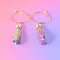 a pair of gold hoop earrings with a pink background
