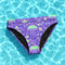 High-waisted cheeky bikini bottoms in a bold purple jellyfish print with iridescent greens and sea-inspired pastels. Made of 81% recycled REPREVE polyester and 19% LYCRA XTRALIFE, these bottoms offer UPF 50+ protection, double-layer construction, and a flattering silhouette. Sizes XS to 3XL. Perfect for festivals, beach days, and summer raves.